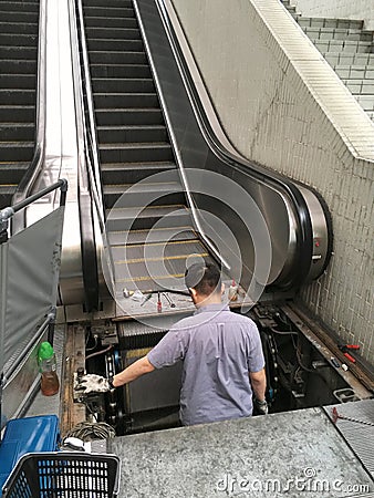 Maintenance technician does escalator service Editorial Stock Photo