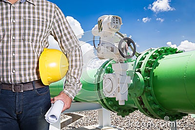 Maintenance technician with pipeline valves of cooling water system in power plant. Stock Photo