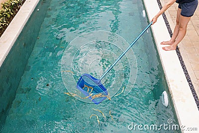 Maintrance with skimmer net tool cleaning swimming pool Stock Photo