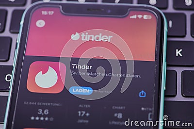 red tinder logo on a smartphone in Germany Editorial Stock Photo