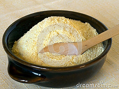 Maize flour, yellow, in bowl. Rustic stone ground. Stock Photo