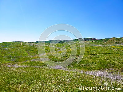 a majestic aerial shot of the lush green hillsides and mountains with a long winding road Stock Photo