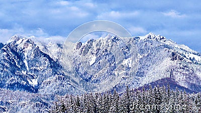 Majestic blue rocky mountains covered in snow Stock Photo