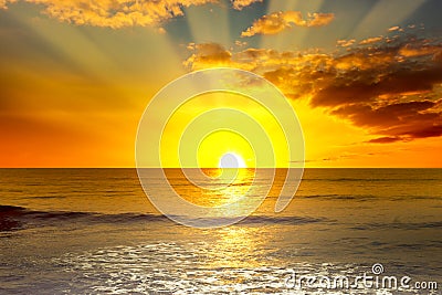 Majestic bright sunrise over ocean and light waves Stock Photo