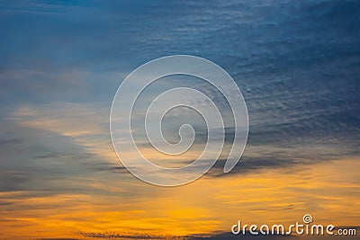 Majestic dusk. Beautiful dark blue sky with vivid golden shades. Dense clouds in twilight orange sky. Cloudy bright sky Stock Photo