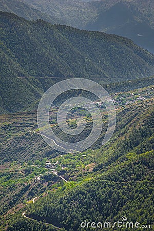 Majestic green grand valley and rural peaceful village Stock Photo