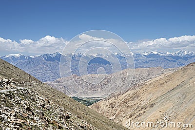 Majestic Himalayas view with green valley and winding road Stock Photo