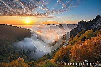 majestic mountain sunrise over misty valley Stock Photo