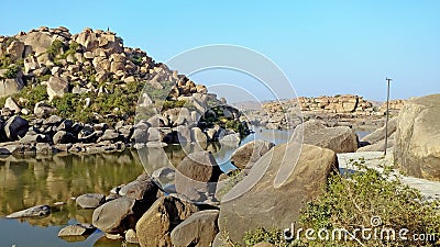 Majestic Mountains, Tranquil River, and Timeless Rocks Stock Photo