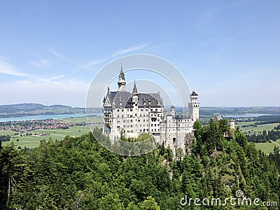 The majestic Neuschwanstein Castle in Bavaria on a sunny, windless day. Stock Photo