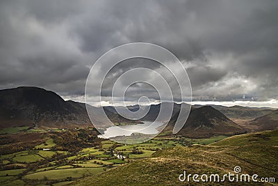 Majestic sun beams light up Crummock Water in epic Autumn Fall landscape image with Mellbreak and Grasmoor Stock Photo