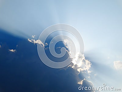 Majestic sun rays penetrate through clouds Stock Photo