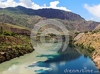 Majestic water combination of two rivers. Dirty-yellow Kara Su flows into bright-blue Naryn Stock Photo