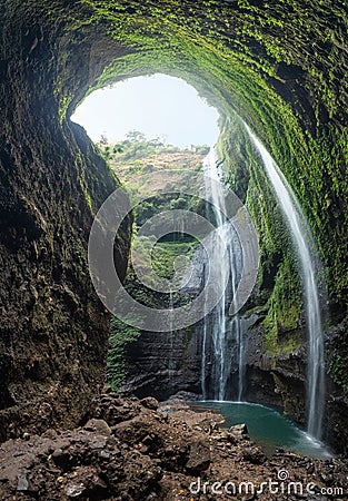 Majestic waterfall flowing on rocky cliff in tropical rainforest Stock Photo