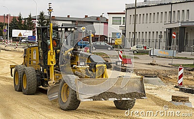 Major road works, leveling. A road grader at work. Editorial Stock Photo