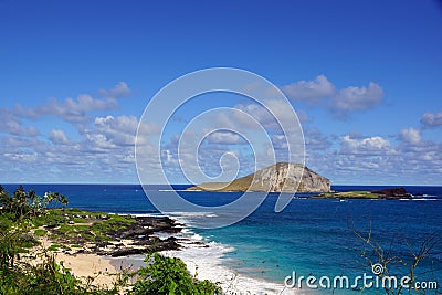 Makapuu beach with people in the water, and Rabbit and Rock Island in the distance Stock Photo