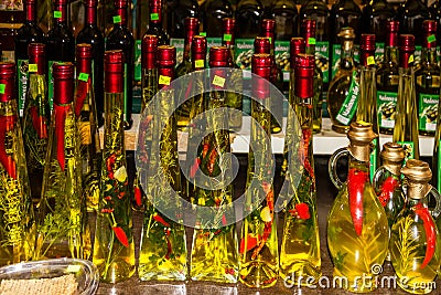 Croatia: Olive oil bottles with pepper on the Makarska market - traditional Croatian souvenirs Editorial Stock Photo