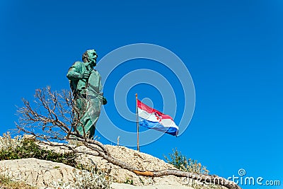 Makarska September 2018 Croatia. Monument to St. Peter and flag of Croatia sea entrance to the Harbor Editorial Stock Photo