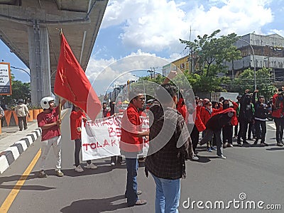 Makassar, Indonesia-11 April 2022- Demonstrators demanding stability in staple food prices and rejecting an 11% tax increase Editorial Stock Photo