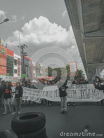 Makassar, Indonesia-11 April 2022- Demonstrators demanding stability in staple food prices and rejecting an 11% tax increase Editorial Stock Photo