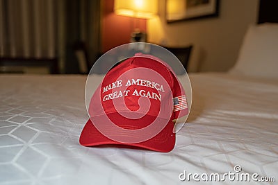 A Make America Great Again red hat sits on a bed. Concept for President Donald Trump re- Editorial Stock Photo