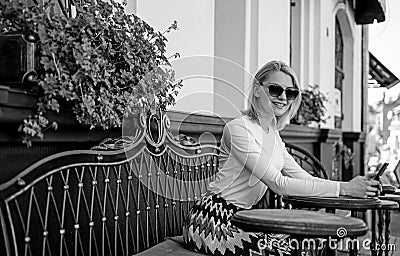 Make appointment. Woman smiling face with smartphone create appointment in social network and wait friends in cafe. Girl Stock Photo