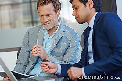 They make a great team. businessmen working in their office. Stock Photo