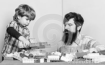 Make with inspiration. building plane with colorful constructor. love. child development. small boy with dad playing Stock Photo