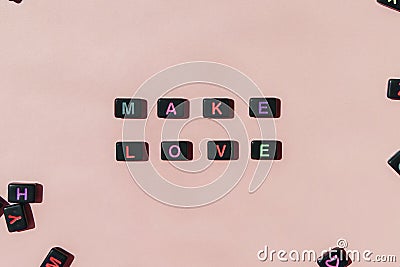 Make love not war. Black beads making phrase on beige background Stock Photo