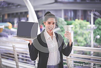 Make money online on computer with rich woman Stock Photo