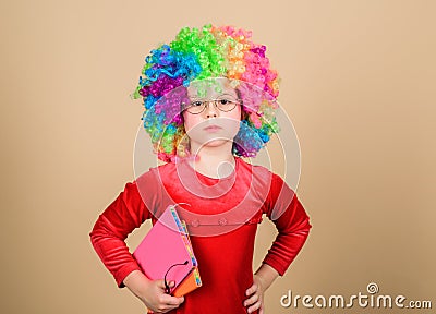 Make studying fun. Truly happy childhood. Girl cute playful child wear curly rainbow wig. Life is fun. Happy little Stock Photo