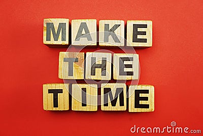 make the time letters alphabet wooden cubes on red background Stock Photo