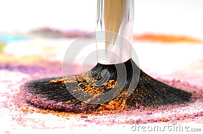 Make-up brush on colorful crushed eyeshadow Stock Photo