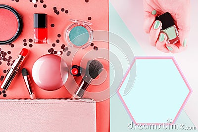 Make up items on pink and mint green. Flat lay Stock Photo