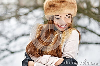 Make a wish! Excited beautiful winter girl with eyes closed. Clo Stock Photo