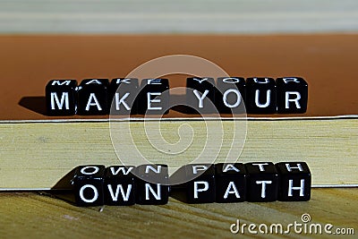 Make your own path on wooden blocks. Motivation and inspiration concept Stock Photo