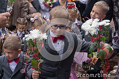 Makeevka, Ukraine - September 1, 2017: First-graders go to the first lesson in school Editorial Stock Photo