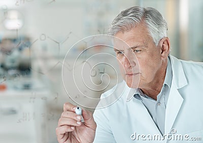 It makes sense once you put everything together. a senior scientist solving equations on a glass screen in a lab. Stock Photo