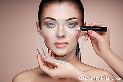 Makeup artist applies skintone Stock Photo