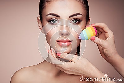Makeup artist applies skintone Stock Photo