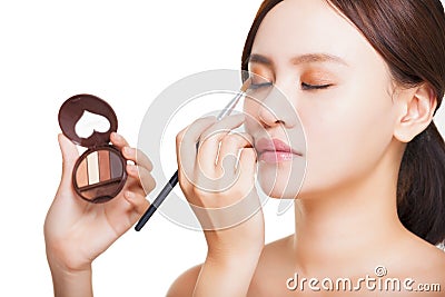 Makeup artist applying colorful eyeshadow on model's eye Stock Photo