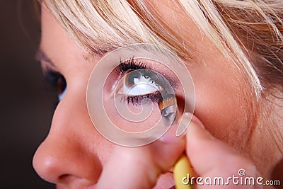 Makeup artist applying eyeshadow Stock Photo