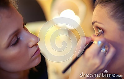 Makeup artist applying eyeshadow Stock Photo