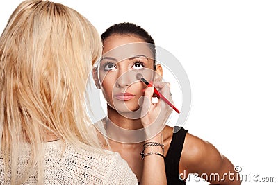 Makeup artist applying makeup to her model Stock Photo