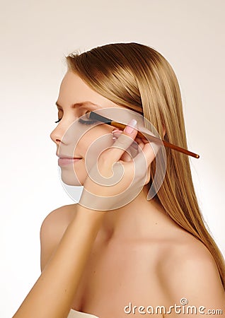 Makeup artist applying mascara Stock Photo
