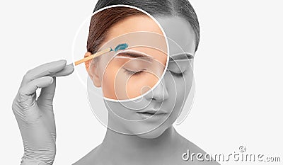 Makeup artist does facial hair removal procedure. Beautiful girl with blue eyes having Permanent Make-up on her Eyebrows. Stock Photo