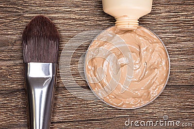 Makeup brush with liquid foundation squeezed out of tube Stock Photo