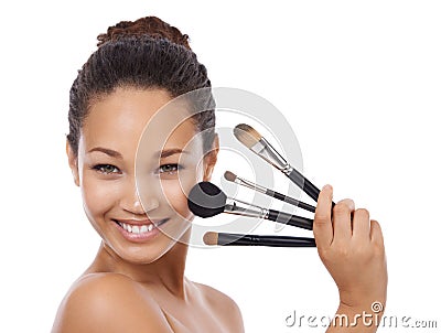 Makeup, brushes and portrait of happy woman in studio for beauty, foundation and cosmetics. Face of young model, artist Stock Photo