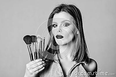 Makeup cosmetics concept. Skin tone concealer. Cosmetics shop. Girl apply eye shadows. Woman applying makeup brush Stock Photo