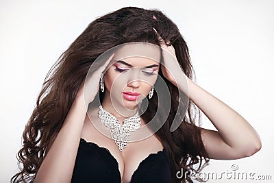 Makeup. Diamond jewelry. Beautiful woman in expensive pendant cl Stock Photo